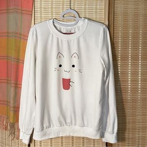 Cute Kawaii-style cat graphic on long-sleeve tee